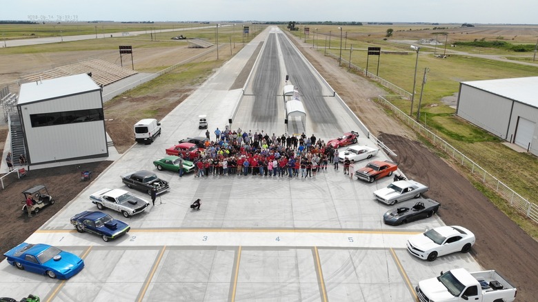 Posnetek od zgoraj nove proge SCRA Dragstrip, medtem ko delavci na progi in podporni člani skupnosti režejo trak ob njeni otvoritvi.