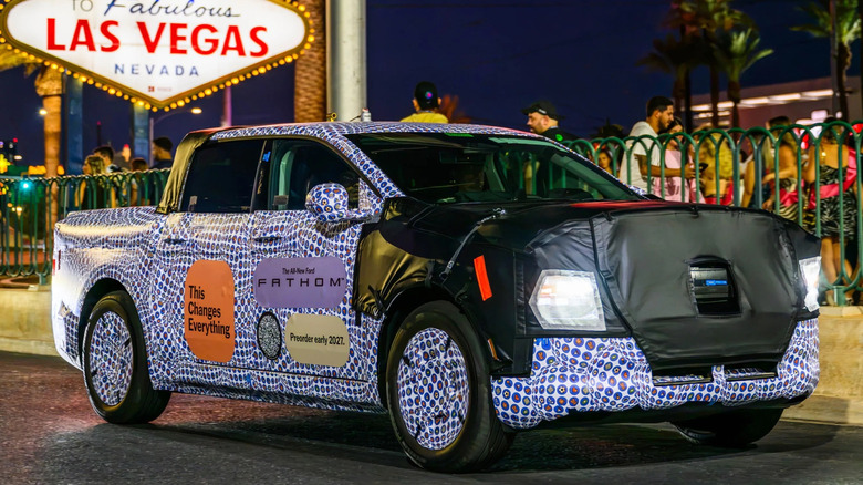 Pogled od spredaj 3/4 kamufliranega prototipa Ford Fathom med vožnjo po Las Vegasu